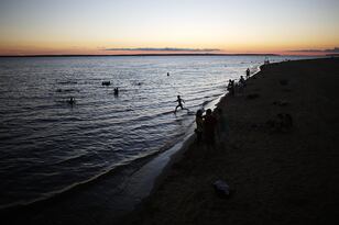 Hi-res-451620465-people-gather-at-ponta-negra-beach-on-rio-negro-a_crop_north