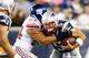FOXBORO, MA - AUGUST 29: Tim Tebow #5 of the New England Patriots is sacked by Matt Broha #54 of the New York Giants in the second half during the preseason game at Gillette Stadium on August 29, 2013 in Foxboro, Massachusetts. (Photo by Jared Wickerham/Getty Images)