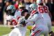 ANN ARBOR, MI - NOVEMBER 30: Quarterback Braxton Miller #5 hands the ball off to running back Carlos Hyde #34 of the Ohio State Buckeyes against the Michigan Wolverines during a game at Michigan Stadium on November 30, 2013 in Ann Arbor, Michigan. (Photo by Gregory Shamus/Getty Images)