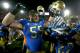 LOS ANGELES, CA - NOVEMBER 30: Ben Wysocki #55 of the UCLA Bruins celebrates with teammates after the game with the USC Trojans at Los Angeles Coliseum on November 30, 2013 in Los Angeles, California. The Bruins won 35-14. (Photo by Stephen Dunn/Getty Images)