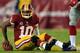 LANDOVER, MD - DECEMBER 01: Robert Griffin III #10 of the Washington Redskins sits on the ground after a play against the New York Giants during their game at FedExField on December 1, 2013 in Landover, Maryland. (Photo by Rob Carr/Getty Images)