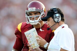 Hi-res-82830560-mark-sanchez-of-the-usc-trojans-talks-with-assistant_crop_north