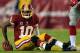 LANDOVER, MD - DECEMBER 01: Robert Griffin III #10 of the Washington Redskins sits on the ground after a play against the New York Giants during their game at FedExField on December 1, 2013 in Landover, Maryland. (Photo by Rob Carr/Getty Images)
