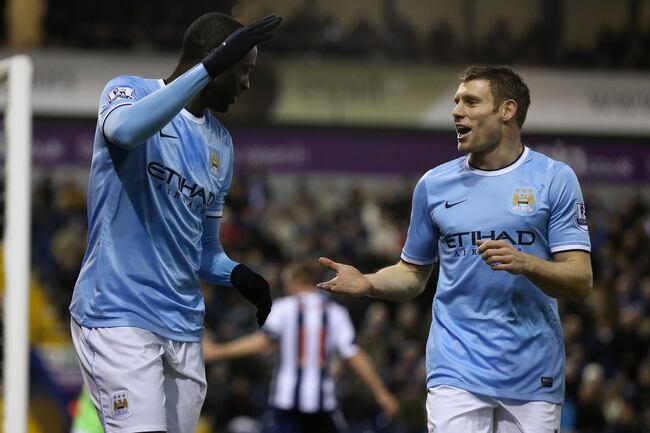 Hi-res-453582875-yaya-toure-of-manchester-city-celebrates-with-team-mate_crop_north