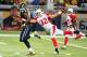 Tyrann Mathieu (right) punches the ball away from St. Louis tight end Jared Cook in Week 1.