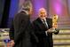 CAPE TOWN, SOUTH AFRICA - DECEMBER 04: FIFA President Sepp Blatter (R) holds the World Cup next to South African President Jacob Zuma (C) during the Final Draw for the FIFA World Cup 2010 December 4, 2009 at the International Convention Centre in Cape Town, South Africa. (Photo by Shaun Botterill/Getty Images)