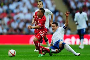 Hi-res-115229007-john-terry-of-england-tackles-granit-xhaka-of_crop_north