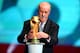 COSTA DO SAUIPE, BRAZIL - DECEMBER 06: Spain coach Vicente del Bosque places the World Cup trophy on a plinth on stage before the Final Draw for the 2014 FIFA World Cup Brazil at Costa do Sauipe Resort on December 6, 2013 in Costa do Sauipe, Bahia, Brazil. (Photo by Clive Mason/Getty Images)