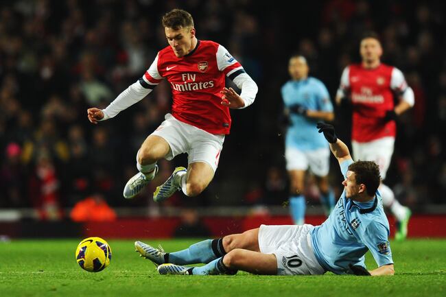 Hi-res-159410069-aaron-ramsey-of-arsenal-is-tackled-by-edin-dzeko-of_crop_north