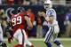 HOUSTON, TX - NOVEMBER 03: Andrew Luck #12 of the Indianapolis Colts drops back as J.J. Watt #99 of the Houston Texans applies pressure in the fourth quarter at Reliant Stadium on November 3, 2013 in Houston, Texas. (Photo by Bob Levey/Getty Images)
