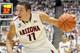 Dec 7, 2013; Tucson, AZ, USA; Arizona Wildcats forward Aaron Gordon (11) dribbles the ball as UNLV Rebels forward Roscoe Smith (1) defends during the first half at McKale Center. Mandatory Credit: Casey Sapio-USA TODAY Sports