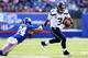 EAST RUTHERFORD, NJ - DECEMBER 15: Russell Wilson #3 of the Seattle Seahawks scrambles as Terrell Thomas #24 of the New York Giants misses the tackle at MetLife Stadium on December 15, 2013 in East Rutherford, New Jersey. (Photo by Elsa/Getty Images)