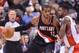 Nov 17, 2013; Toronto, Ontario, CAN; Portland Trail Blazers power forward LaMarcus Aldridge (12) tries to get the ball past Toronto Raptors power forward Amir Johnson (15) during the third quarter of a game at the Air Canada Centre. Portland won the game 118-110. Mandatory Credit: Mark Konezny-USA TODAY Sports