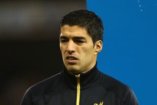 Hi-res-456837441-luis-suarez-of-liverpool-waits-with-the-mascot-to-lead_crop_north