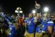 LOS ANGELES, CA - NOVEMBER 30: Carl Hulick #57 of the UCLA Bruins celebrates with teammates after the game with the USC Trojans at Los Angeles Coliseum on November 30, 2013 in Los Angeles, California. The Bruins won 35-14. (Photo by Stephen Dunn/Getty Images)