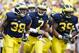 Aug 31, 2013; Ann Arbor, MI, USA; Michigan Wolverines running back Thomas Rawls (38) quarterback Shane Morris (7) and fullback Sione Houma (39) celebrate a touchdown by Rawls second half against the Central Michigan Chippewas t Michigan Stadium. Mandatory Credit: Rick Osentoski-USA TODAY Sports
