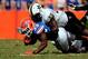 GAINESVILLE, FL - NOVEMBER 09: Caleb Azubike #55 of the Vanderbilt Commodores tackles Mack Brown #33 of the Florida Gators during a game at Ben Hill Griffin Stadium on November 9, 2013 in Gainesville, Florida. Vanderbilt won the game 34-17. (Photo by Stacy Revere/Getty Images)