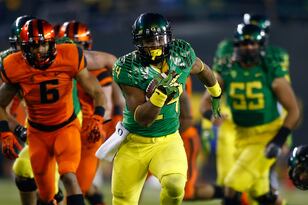 Hi-res-452562273-thomas-tyner-of-the-oregon-ducks-runs-against-the_crop_north