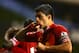 LONDON, ENGLAND - DECEMBER 15: Luis Suarez of Liverpool celebrates scoring their fourth goal during the Barclays Premier League match between Tottenham Hotspur and Liverpool at White Hart Lane on December 15, 2013 in London, England. (Photo by Paul Gilham/Getty Images)