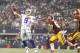 Oct 13, 2013; Arlington, TX, USA; Dallas Cowboys quarterback Tony Romo (9) throws a touchdown pass while being rushed by Washington Redskins inside linebacker Perry Riley (56) in the third quarter of the game at AT&T Stadium. The Dallas Cowboys beat the Washington Redskins 31-16. Mandatory Credit: Tim Heitman-USA TODAY Sports