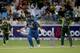 DUBAI, UNITED ARAB EMIRATES - DECEMBER 20: Thisara Perera of Sri Lanka bats as Umar Akmal of Pakistan looks on during the second One-Day International (ODI ) match between Sri Lanka and Pakistan at the Dubai Sports City Cricket Stadium on December 20, 2013 in Dubai, United Arab Emirates. (Photo by Francois Nel/Getty Images)