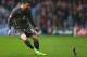 LONDON, ENGLAND - DECEMBER 21: David Nugent of Leiester City chases a squirrel off the pitch after play was delayed during the Sky Bet Championship match between Queens Park Rangers and Leicester City at Loftus Road on December 21, 2013 in London, England. (Photo by Paul Gilham/Getty Images)