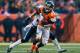 DENVER, CO - DECEMBER 8: Wide receiver Wes Welker #83 of the Denver Broncos is tackled in the open field by cornerback Jason McCourty #30 of the Tennessee Titans during a game at Sports Authority Field Field at Mile High on December 8, 2013 in Denver, Colorado. (Photo by Dustin Bradford/Getty Images)
