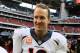 HOUSTON, TX - DECEMBER 22: Peyton Manning #18 of the Denver Broncos celebrates as he walks off the field after setting the NFL record for touchdown passes in a season with 51 in a 37-13 defeat of the Houston Texans at Reliant Stadium on December 22, 2013 in Houston, Texas. (Photo by Scott Halleran/Getty Images)