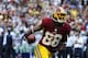Dec 8, 2013; Landover, MD, USA; Washington Redskins wide receiver Pierre Garcon (88) scores a touchdown as Dallas Cowboys cornerback Brandon Carr (39) looks on during the second half at FedEx Field. Mandatory Credit: Brad Mills-USA TODAY Sports