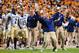 Sep 22, 2012; Knoxville, TN, USA; Akron Zips offensive line coach Alan Arrington celebrates the 70 yard touchdown run by Akron running back Quentin Hines (not pictured) against the Tennessee Volunteers during the first half at Neyland Stadium. Mandatory Credit: Jim Brown-USA TODAY Sports