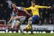 LONDON, ENGLAND - DECEMBER 26: Aaron Ramsey of Arsenal holds off Kevin Nolan of West Ham United during the Barclays Premier League match between West Ham United and Arsenal at Boleyn Ground on December 26, 2013 in London, England. (Photo by Ian Walton/Getty Images)