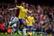 LONDON, ENGLAND - DECEMBER 26: Theo Walcott of Arsenal is chased by Kevin Nolan of West Ham United during the Barclays Premier League match between West Ham United and Arsenal at Boleyn Ground on December 26, 2013 in London, England. (Photo by Bryn Lennon/Getty Images)