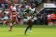 LONDON, ENGLAND - AUGUST 18: Carlin Isles of San Francisco races away with the ball in the match against Gloucester during the World Club 7's at Twickenham Stadium on August 18, 2013 in London, England. (Photo by David Rogers/Getty Images)
