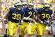 Aug 31, 2013; Ann Arbor, MI, USA; Michigan Wolverines running back Thomas Rawls (38) quarterback Shane Morris (7) and fullback Sione Houma (39) celebrate a touchdown by Rawls second half against the Central Michigan Chippewas t Michigan Stadium. Mandatory Credit: Rick Osentoski-USA TODAY Sports