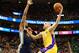 Dec 27, 2013; Salt Lake City, UT, USA; Los Angeles Lakers center Chris Kaman (9) drives to the basket while being guarded by Utah Jazz power forward Derrick Favors (15) during the first quarter at EnergySolutions Arena. Mandatory Credit: Chris Nicoll-USA TODAY Sports