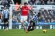 NEWCASTLE UPON TYNE, ENGLAND - DECEMBER 29: Olivier Giroud of Arsenal challenges Vurnon Anita of Newcastle United during the Barclays Premier League match between Newcastle United and Arsenal at St James' Park on December 29, 2013 in Newcastle upon Tyne, England. (Photo by Jan Kruger/Getty Images)