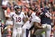 Dec 22, 2013; Houston, TX, USA; Denver Broncos quarterback Peyton Manning (18) passes while being rushed by Houston Texans defensive end J.J. Watt (99) during the second half at Reliant Stadium. The Broncos won 37-13. Mandatory Credit: Thomas Campbell-USA TODAY Sports