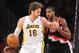 December 1, 2013; Los Angeles, CA, USA; Los Angeles Lakers center Pau Gasol (16) moves the ball against the defense of Portland Trail Blazers power forward LaMarcus Aldridge (12) during the first half at Staples Center. Mandatory Credit: Gary A. Vasquez-USA TODAY Sports