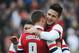 BRIGHTON, ENGLAND - JANUARY 26: Olivier Giroud of Arsenal (12) celebrates with team mate Lukas Podolski as he scores their first goal during the FA Cup with Budweiser Fourth Round match between Brighton & Hove Albion and Arsenal at Amex Stadium on January 26, 2013 in Brighton, England. (Photo by Steve Bardens/Getty Images)