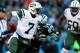 CHARLOTTE, NC - DECEMBER 15: Geno Smith #7 of the New York Jets runs with the ball as Greg Hardy #76 of the Carolina Panthers chases him down during their game at Bank of America Stadium on December 15, 2013 in Charlotte, North Carolina. (Photo by Streeter Lecka/Getty Images)
