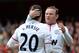 LONDON, ENGLAND - APRIL 28: Wayne Rooney of Manchester United congratulates Robin van Persie of Manchester United after he scored from the penalty spot to make it 1-1 during the Barclays Premier League match between Arsenal and Manchester United at Emirates Stadium on April 28, 2013 in London, England. (Photo by Shaun Botterill/Getty Images)