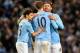 MANCHESTER, ENGLAND - DECEMBER 28: Edin Dzeko of Manchester City is congratulated by team-mates Javi Garcia (r) and Jesus Navas (l) during the Barclays Premier League match between Manchester City and Crystal Palace at the Etihad Stadium on December 28, 2013 in Manchester, England. (Photo by Clint Hughes/Getty Images)