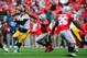 Oct 19, 2013; Columbus, OH, USA; Iowa Hawkeyes quarterback Jake Rudock (15) avoids pressure from Ohio State Buckeyes defensive lineman Noah Spence (8) during the second quarter at Ohio Stadium. Mandatory Credit: Andrew Weber-USA TODAY Sports