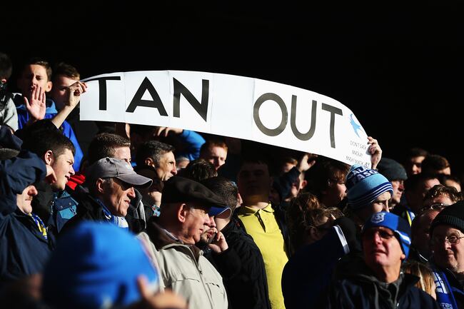 Hi-res-458335561-fans-display-a-banner-showing-their-displeasure-for_crop_north
