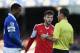 LIVERPOOL, ENGLAND - DECEMBER 29: Adam Lallana of Southampton and Sylvain Distin of Everton are spoken to by Referee Mark Clattenburg during the Barclays Premier League match between Everton and Southampton at Goodison Park on December 29, 2013 in Liverpool, England. (Photo by Clive Brunskill/Getty Images)