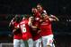 LONDON, ENGLAND - OCTOBER 01: Mesut Oezil (C)of Arsenal is congratulated by teammates after scoring the opening goal during UEFA Champions League Group F match between Arsenal FC and SSC Napoli at Emirates Stadium on October 1, 2013 in London, England. (Photo by Paul Gilham/Getty Images)