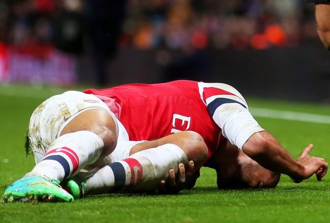 Hi-res-460993535-theo-walcott-of-arsenal-lies-injured-on-the-pitch_crop_north