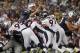 Pats 7, 2012; Foxboro, Massachusetts, USA; New England Patriots quarterback Tom Brady (12) goes over the pile to score a touchdown against the Denver Broncos during the third quarter at Gillette Stadium. Mandatory Credit: Greg M. Cooper-USA TODAY Sports