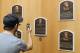 COOPERSTOWN, NY - JULY 24: A patron of the Baseball Hall of Fame and Museum takes a photograph of the plaques of inducted members during induction weekend on July 24, 2010 in Cooperstown, New York. (Photo by Jim McIsaac/Getty Images)