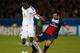 PARIS, FRANCE - NOVEMBER 05: Cheikhou Kouyate of Anderlecht (L) is tackled by Ezequiel Lavezzi of PSG during the UEFA Champions League Group C match between Paris Saint Germain and RSC Anderlecht at Parc des Princes on November 5, 2013 in Paris, France. (Photo by Harry Engels/Getty Images)